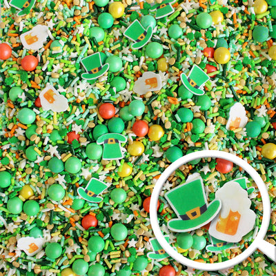 "Shenanigans Sprinkle Mix for St. Patrick's Day - vibrant green sprinkles with yellow and orange accents, featuring wafer paper beer mugs and leprechaun hats."